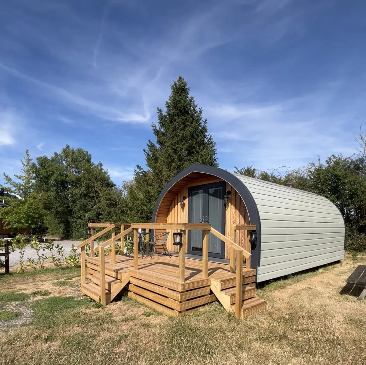 Emily Pod with its timber decking under a blue sky
