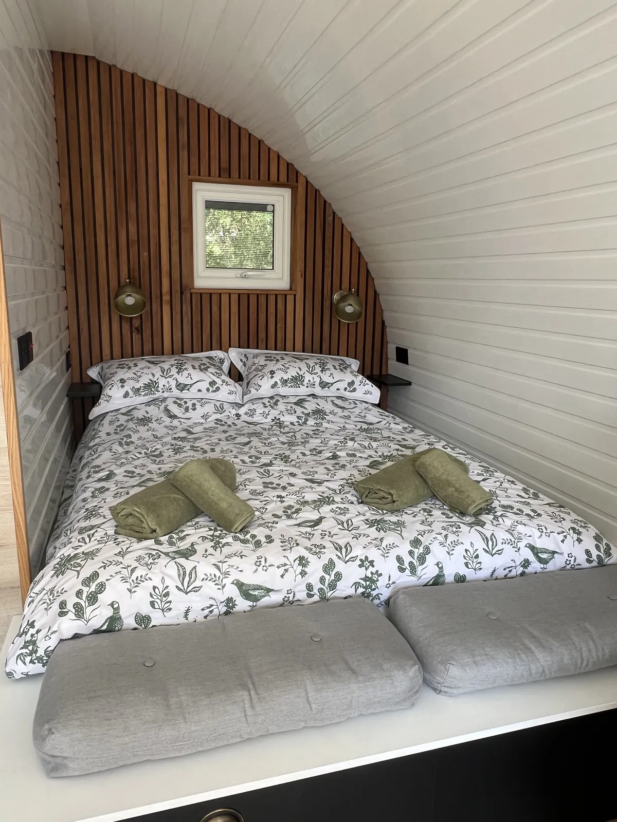 King size bed with bed linen and towels