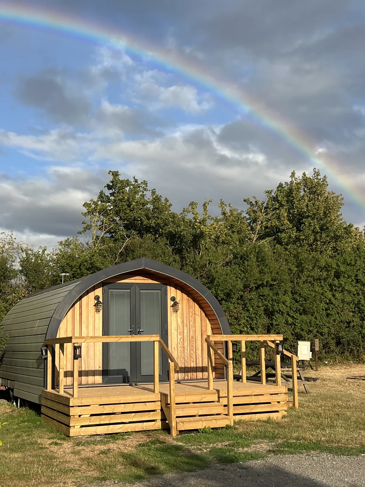 Emily Pod with a rainbow overhead